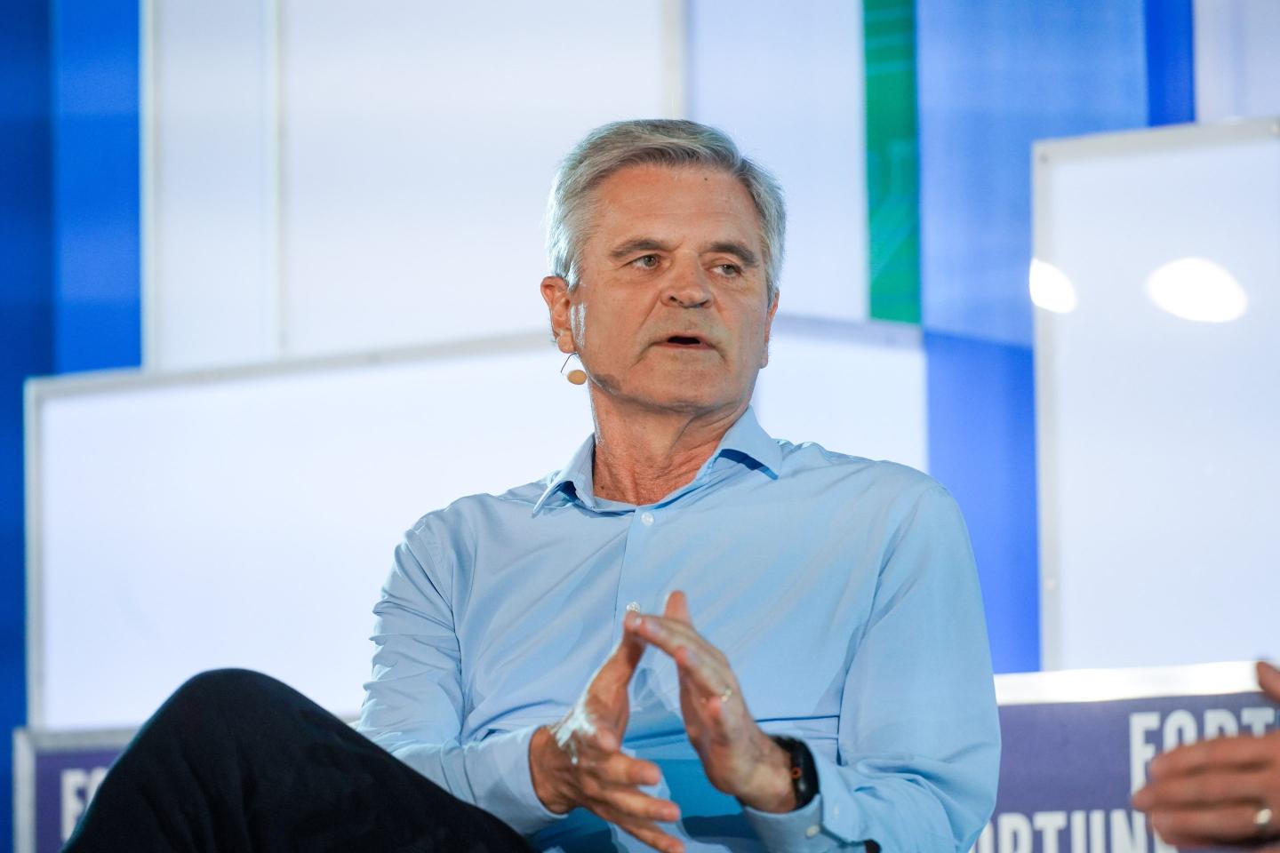 Man in a blue shirt gesturing