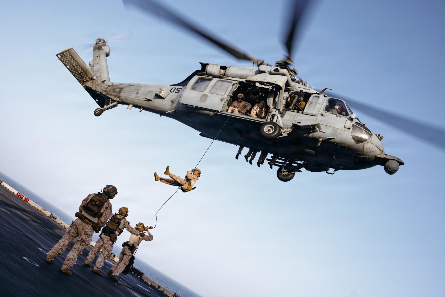 Marines and sailors with Maritime Raid Force, 31st Marine Expeditionary Unit, rappel out of an MH-60S Sea Hawk assigned to Helicopter Sea Combat Squadron (HSC) 25, during rappelling training aboard forward-deployed America class assault ship USS Tripoli (LHA 7) in the U.S. Central Command area of responsibility, May 27, 2026.