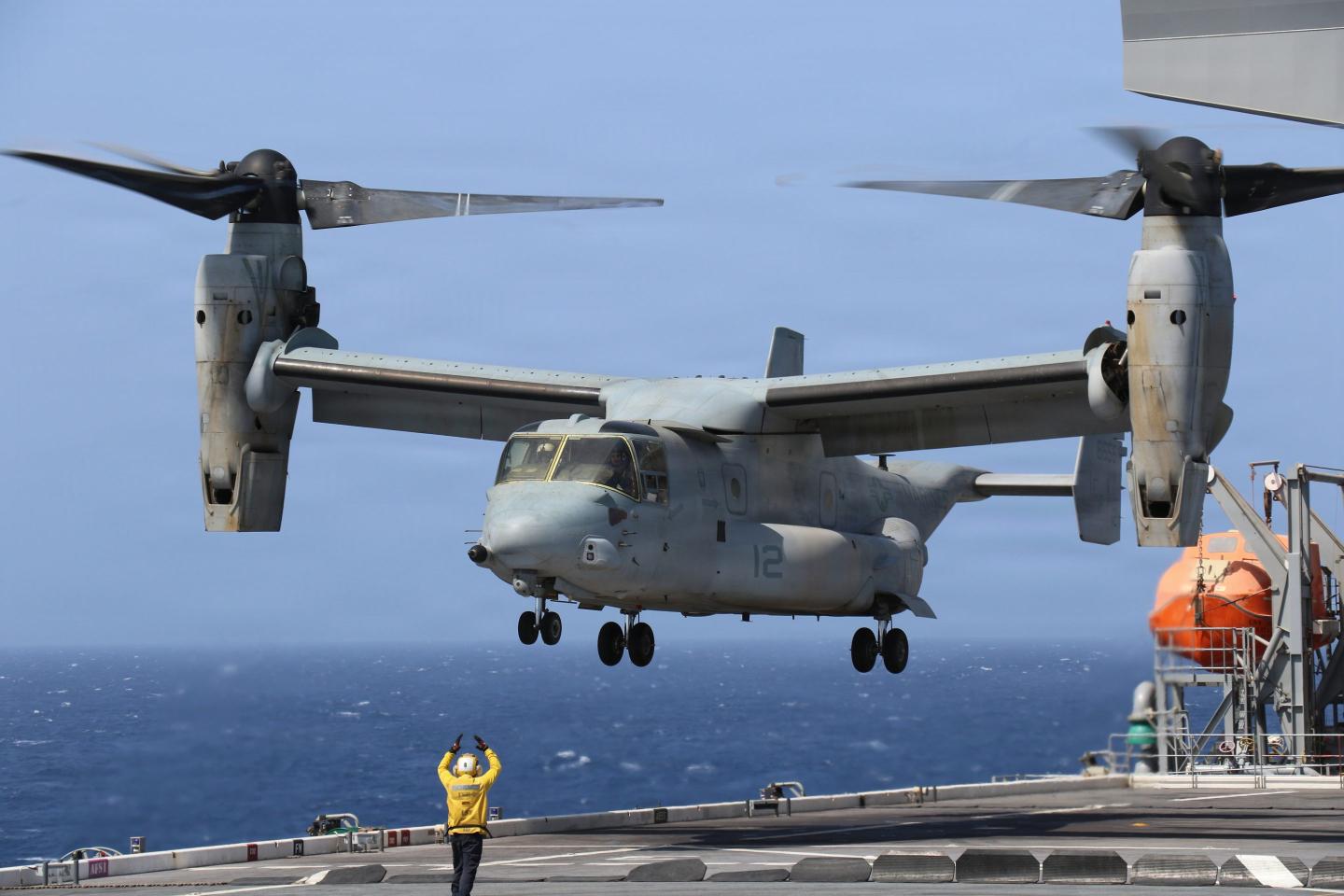 A U.S. sailor signals a V-22 Osprey assigned to America-class amphibious assault ship USS Tripoli (LHA-7) aboard Lewis B. Puller-class expeditionary sea base USS Miguel Keith (ESB 5), June 8, 2026.