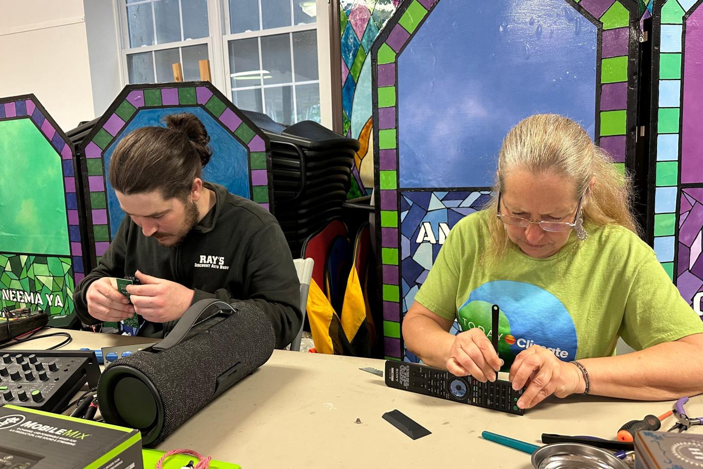 Electronic repair coach Dan Casey and his mother Diane Casey work on a sound-mixing device at a Repair Café in New Paltz, N.Y., May 23, 2026.