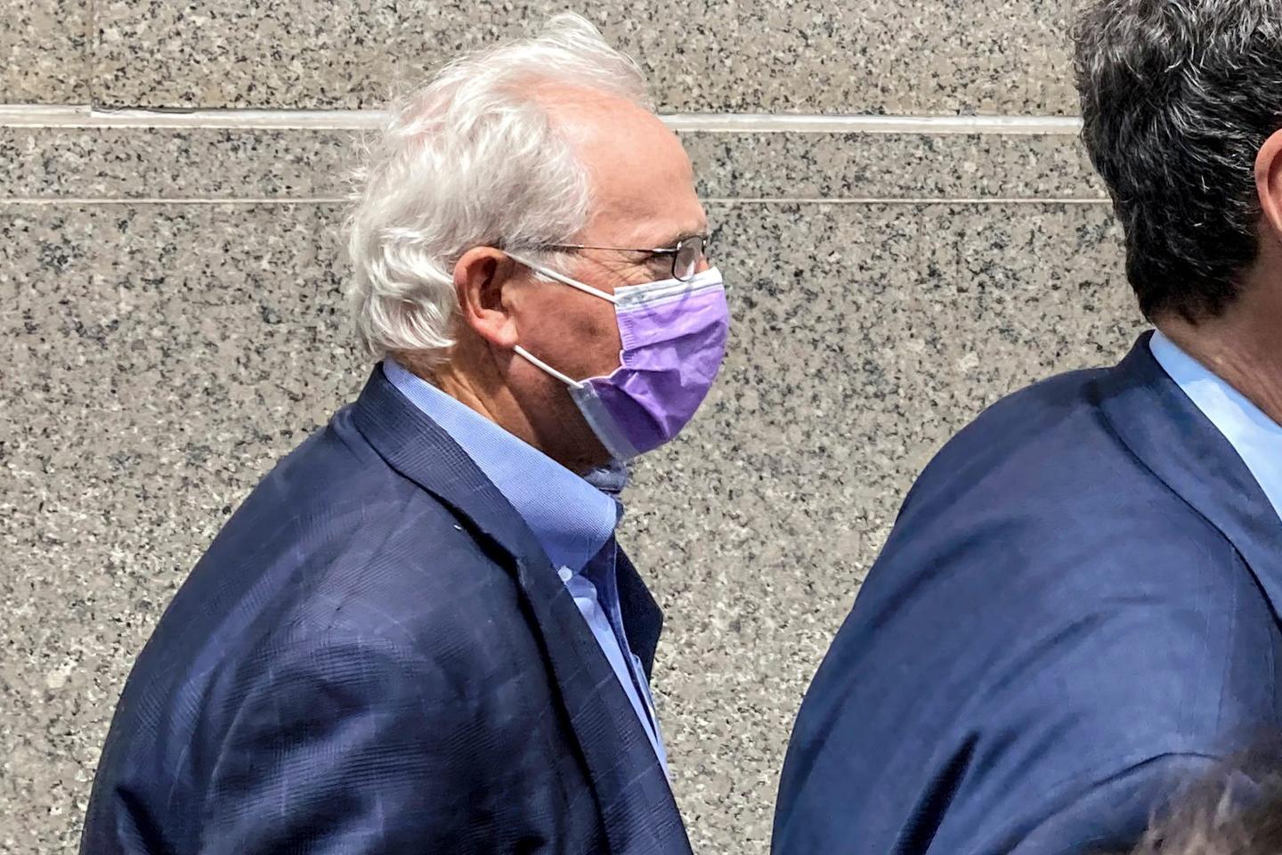 Former U.S. Rep. Stephen Buyer, left, trails his lawyer as he leaves Manhattan federal court after pleading not guilty to charges that he participated in an insider trading scheme while working as a consultant, July 27, 2022, in New York.