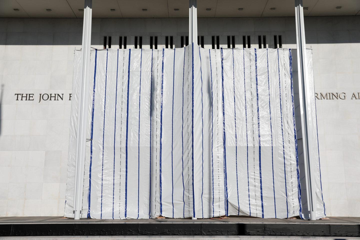 The wall of the John F. Kennedy Center for the Performing Arts is covered in tarp after President Donald Trump's name was removed, in Washington, Saturday, June 13, 2026. 