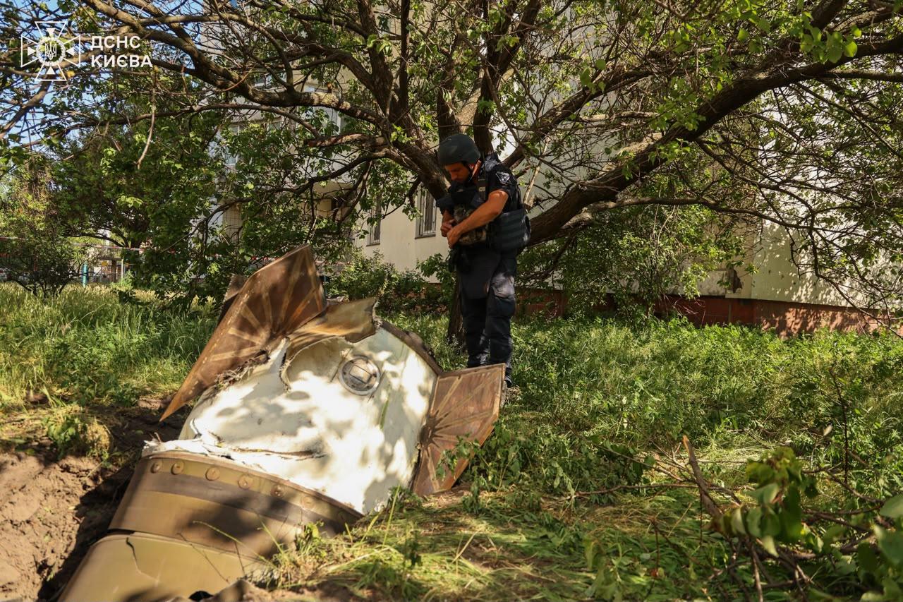 A sapper examines a fragment of the Russian missile in a residential neighbourhood following an air attack in Kyiv, Ukraine, Sunday, June 28, 2026. 