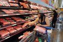Shoppers search for meat and pork product inside Walmart store