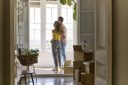 Young couple standing in a brightly lit home