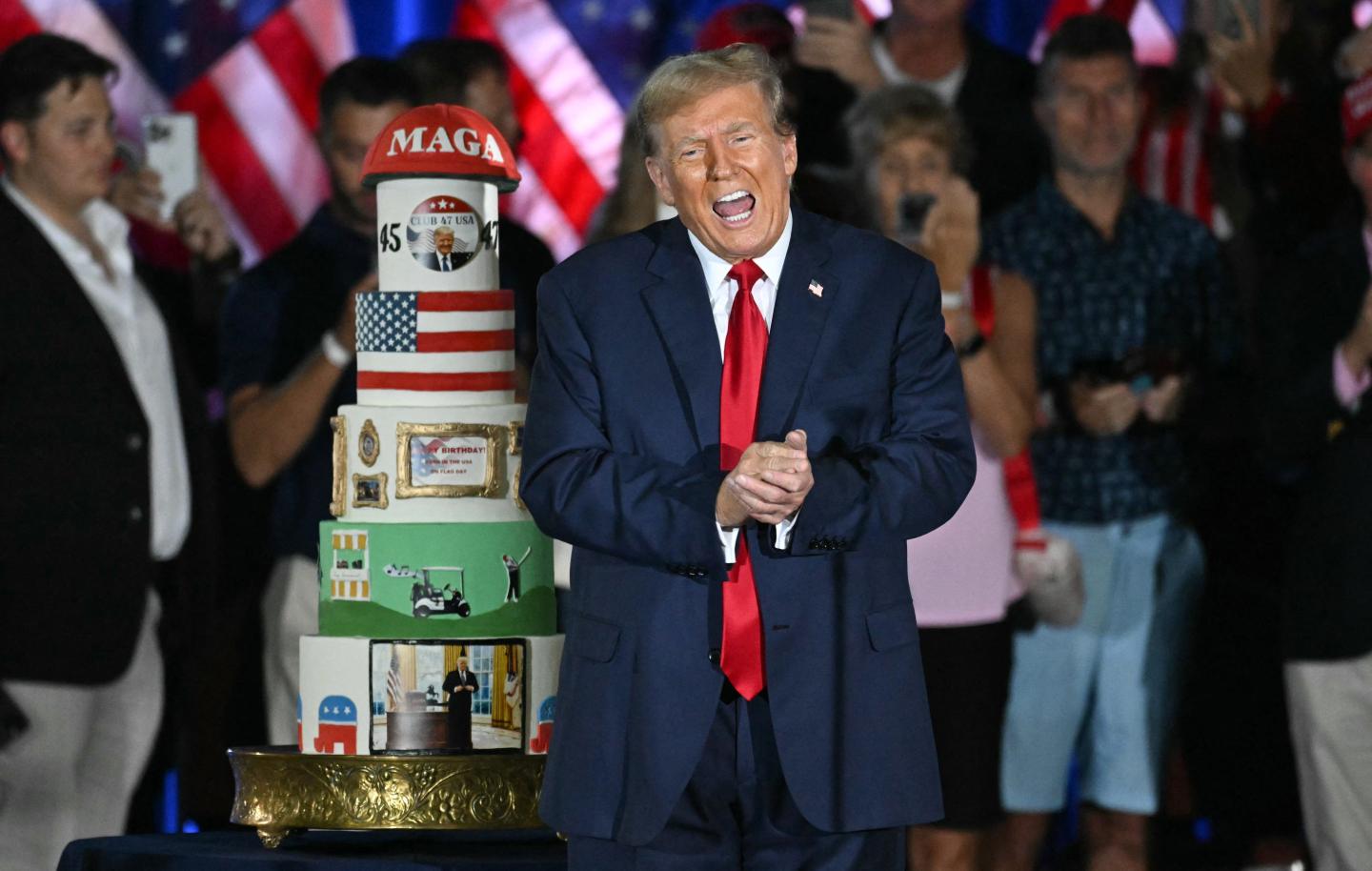 Donald Trump gestures by his birthday cake, created by Club 47, during a campaign rally as he celebrates his 78th birthday at West Palm Convention Center, in West Palm Beach, Florida, on June 14, 2024.