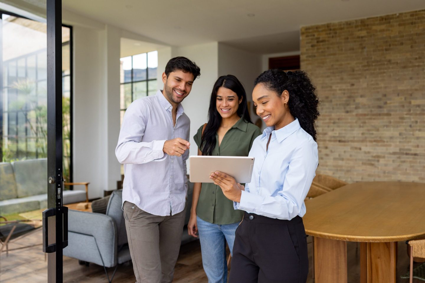 Young real estate agent with clients at house