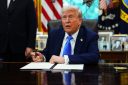 President Donald Trump pictured in September 2025 signing an executive order that overhauled the H-1B visa program.