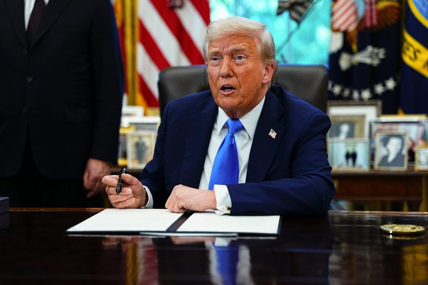 President Donald Trump pictured in September 2025 signing an executive order that overhauled the H-1B visa program.