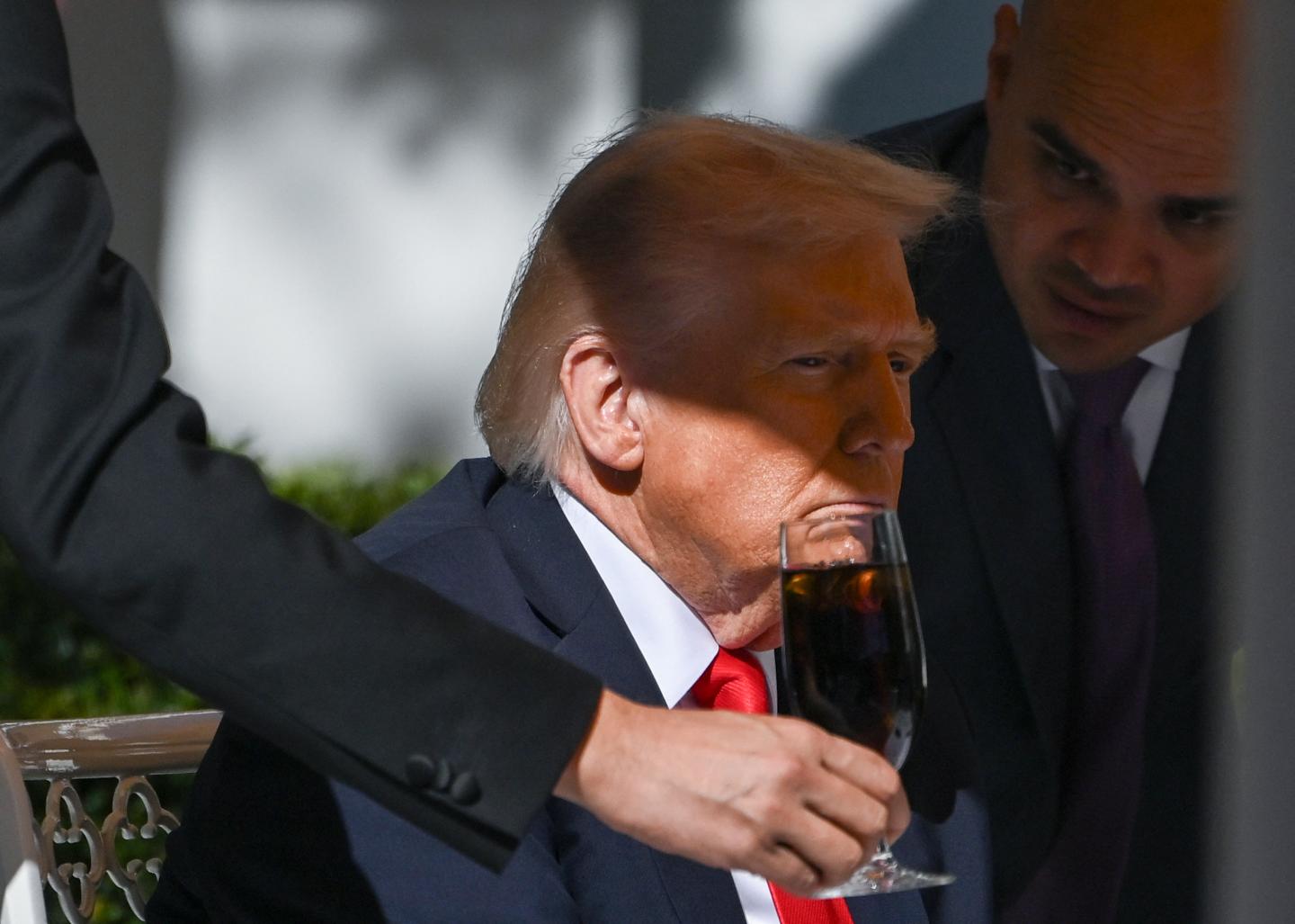 A man put a drink in front of Trump