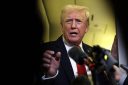 Trump speaking into a mic.