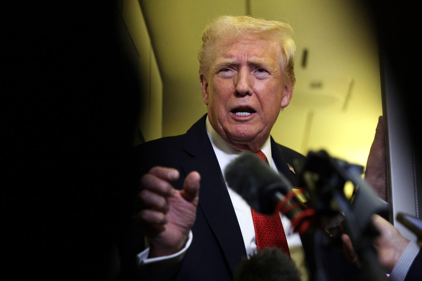 Trump speaking into a mic.