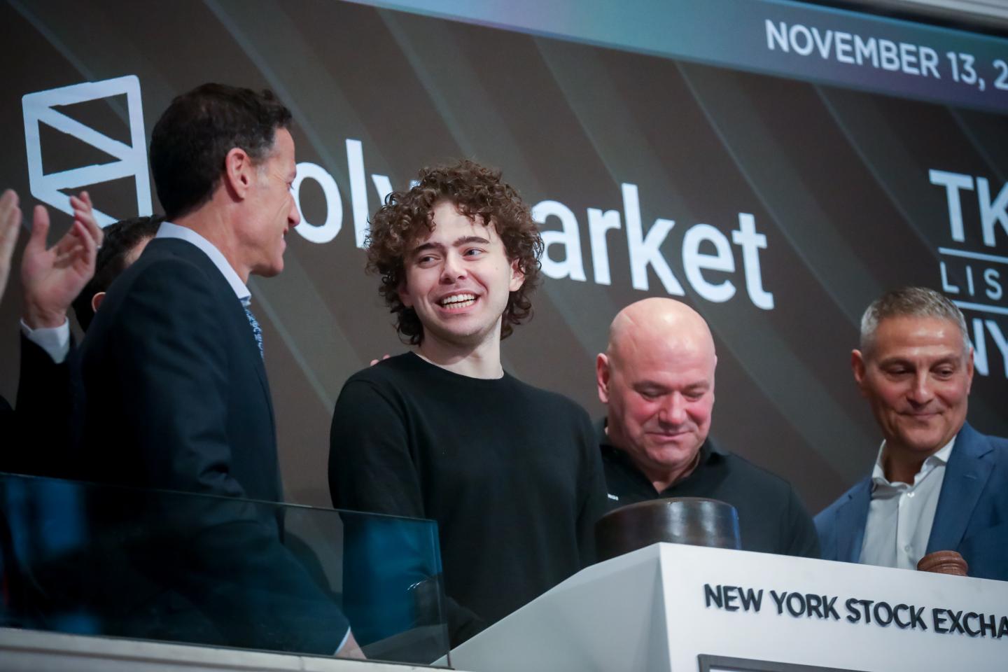 Shayne Coplan, CEO of Polymarket (center, smiling), with TKO Group president and COO Mark Shapiro (left), UFC president Dana White (right), and TKO Group CEO Ari Emanuel (far right) on the floor of the New York Stock Exchange on Nov. 13, 2025. (Photo: Michael Nagle/Bloomberg/Getty Images)