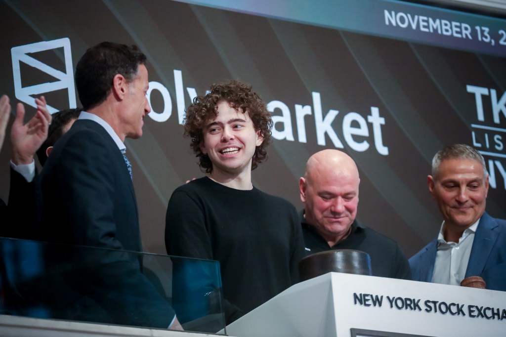 Shayne Coplan, CEO of Polymarket (center, smiling), with TKO Group president and COO Mark Shapiro (left), UFC president Dana White (right), and TKO Group CEO Ari Emanuel (far right) on the floor of the New York Stock Exchange on Nov. 13, 2025. (Photo: Michael Nagle/Bloomberg/Getty Images)