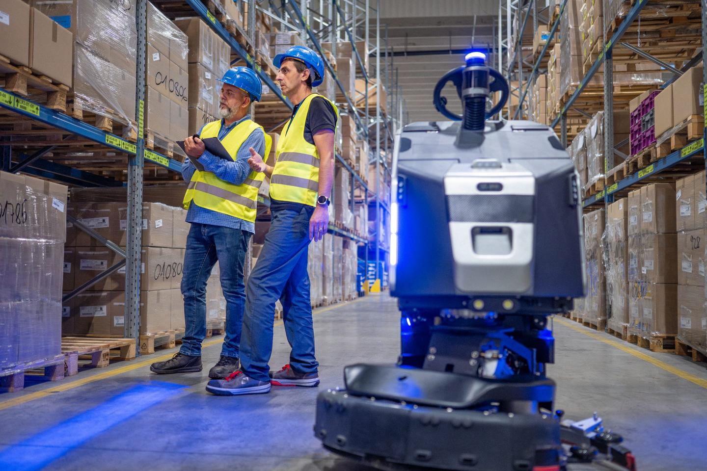 Warehouse workers with robot