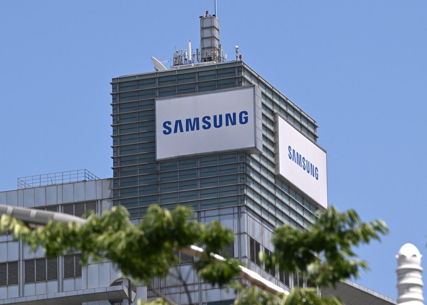 The logo of Samsung Electronics is seen on the top of a building at the company's headquarters in Suwon on May 22, 2026.