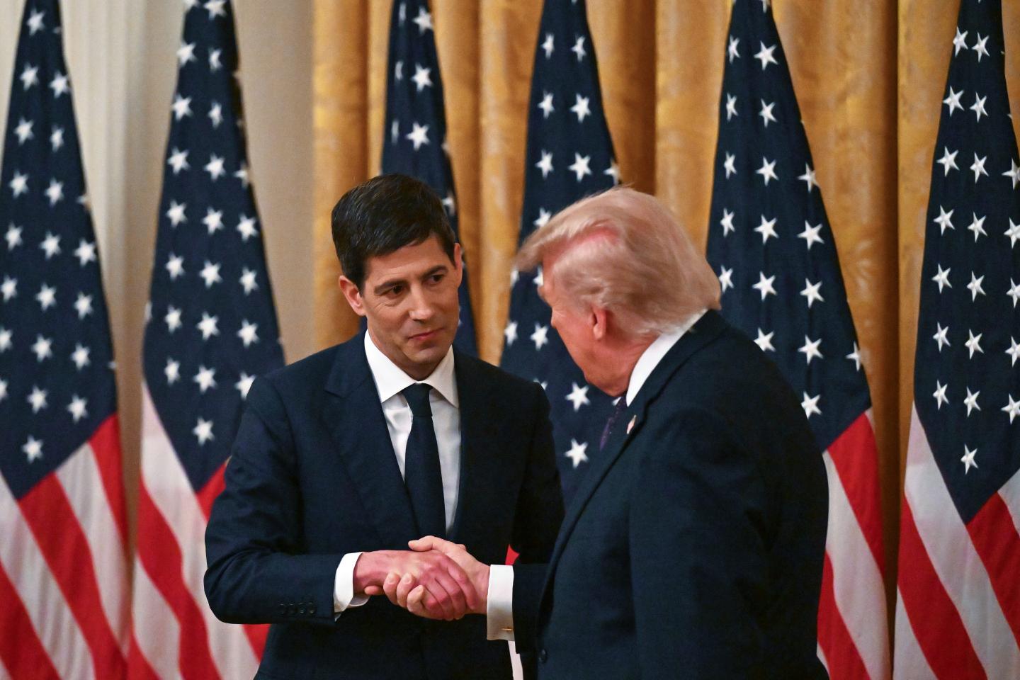 Kevin Warsh (L) shakes hands with U.S. President Donald Trump after being sworn in as the new Chairman of the Federal Reserve in the East Room of the White House on May 22, 2026 in Washington, DC.