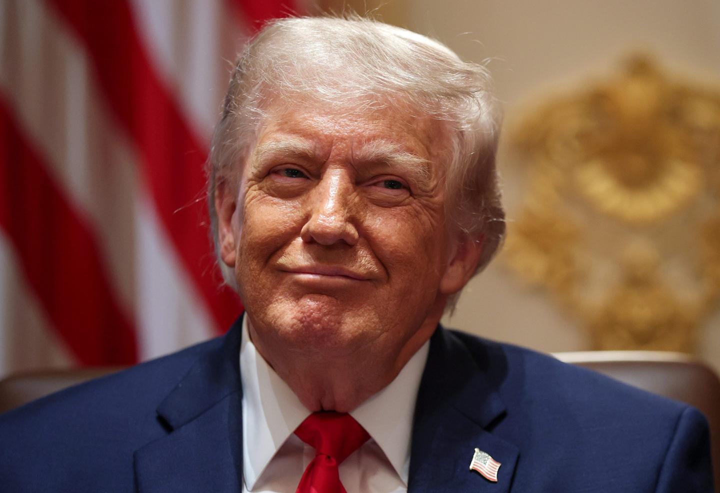 Donald Trump smirks and tilts his head slightly to the side.