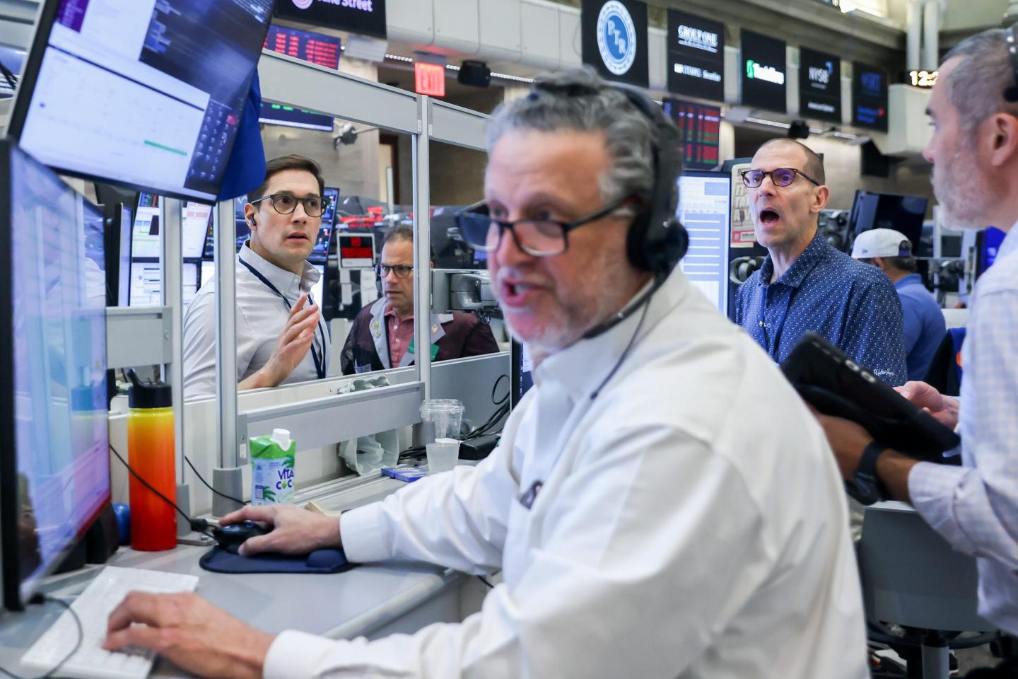 Traders sitting at computers react