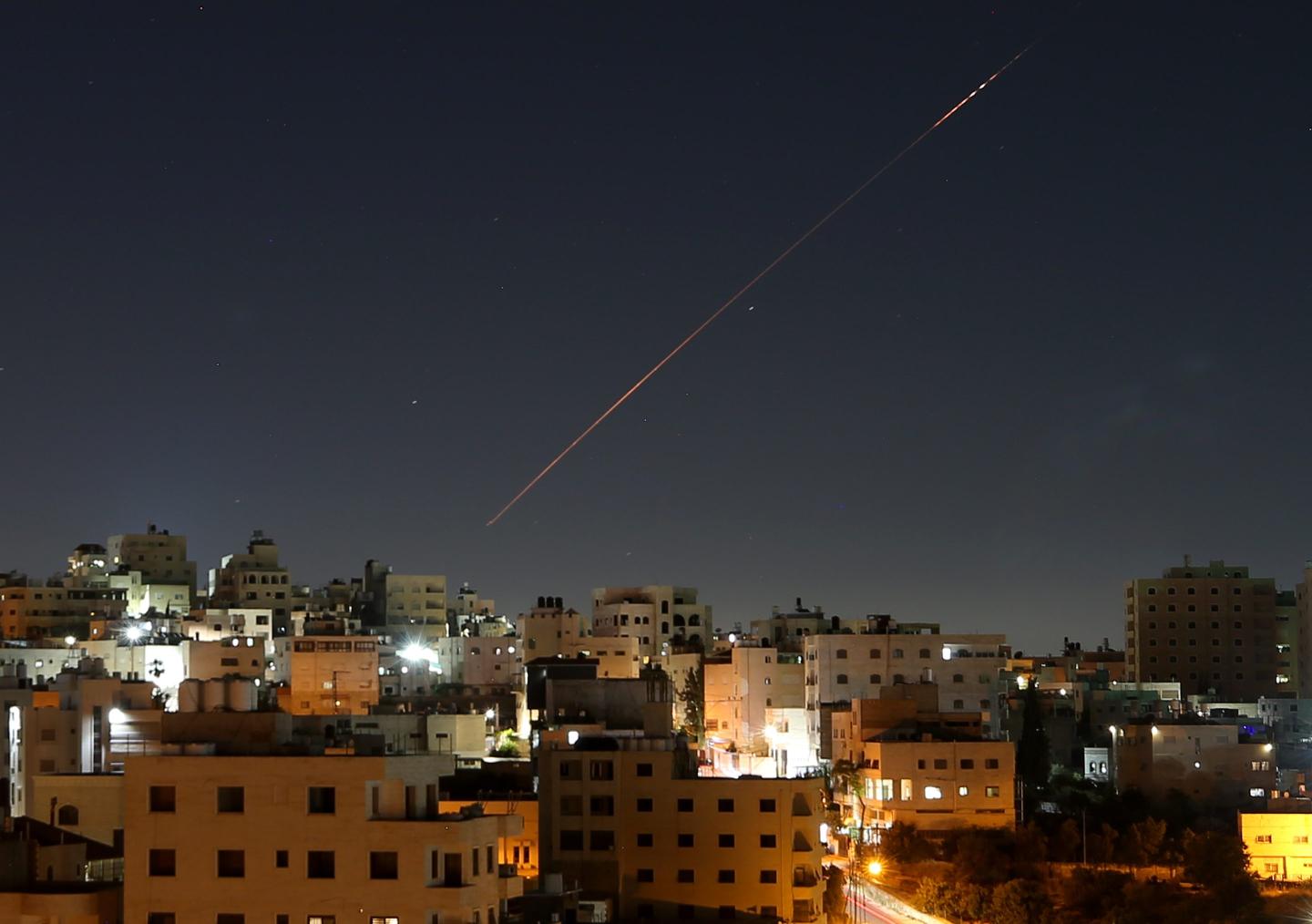 Missiles launched from Iran toward Israel are seen in the sky over the West Bank city of Hebron on June 7, 2026.