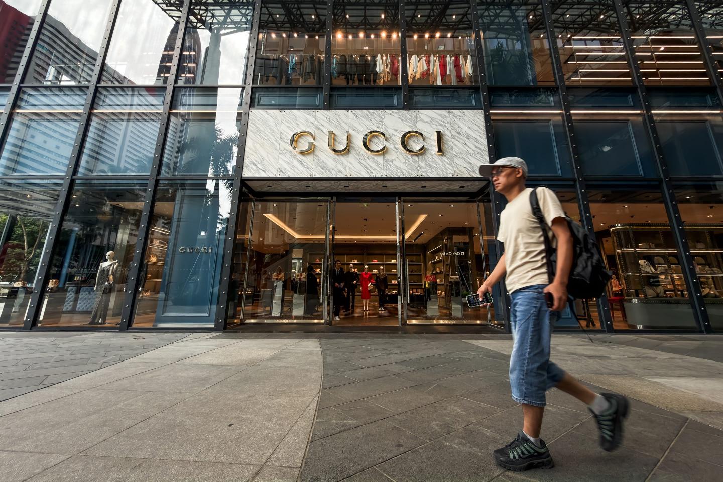 A pedestrian walks past a Gucci luxury fashion store at a shopping district on June 24, 2026, in Shenzhen, Guangdong Province, China.