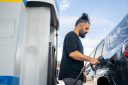 A man pumps his car with gas.