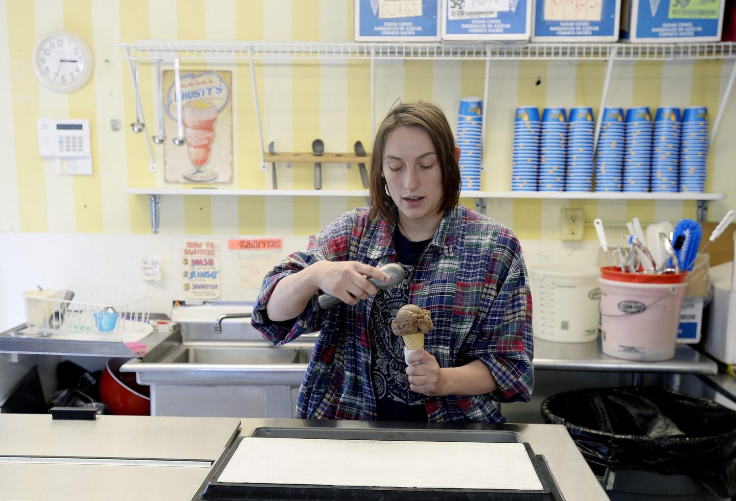 Teenager working in ice cream shop