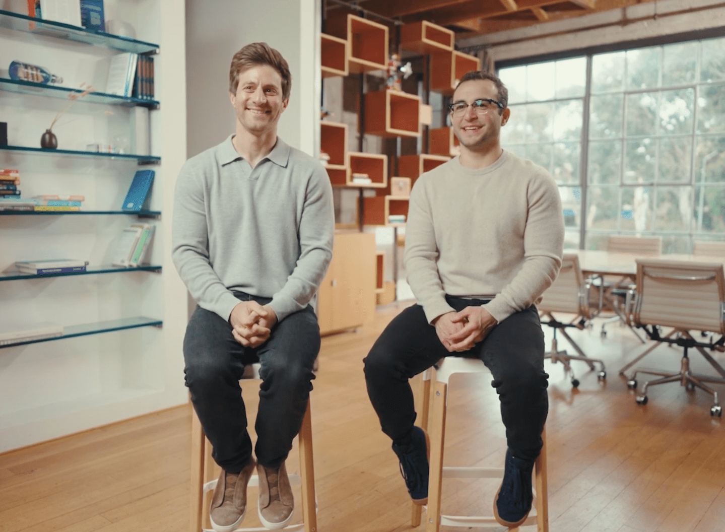 Nick Noone and Ben Rudolph sit on stools