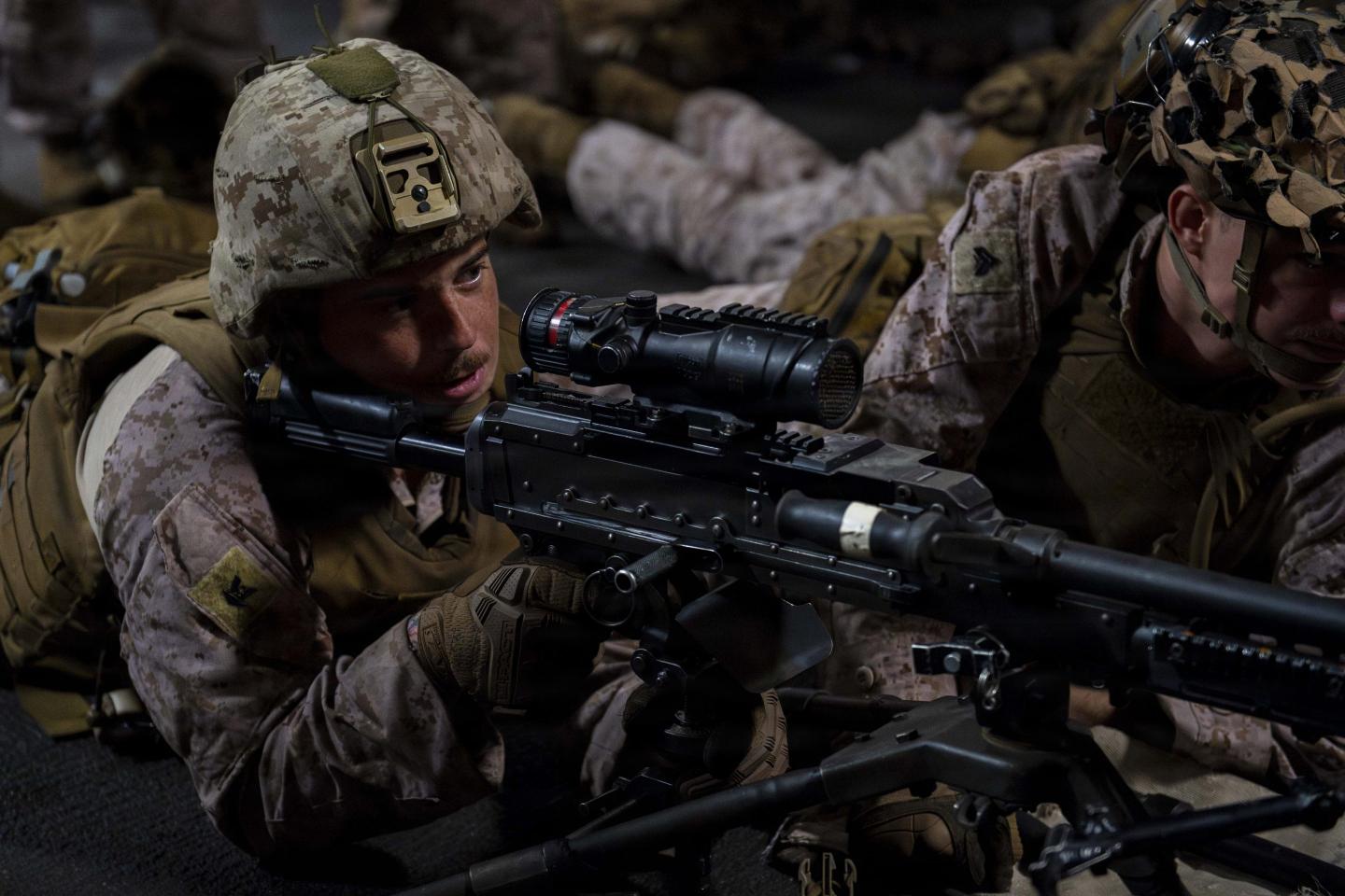 A U.S. sailor, assigned to Battalion Landing Team 3/5, 11th Marine Expeditionary Unit (MEU), participates in a live-fire drill using an M240B machine gun in the upper vehicle deck of Wasp-class amphibious assault ship USS Boxer (LHD 4), July 15, 2026. 