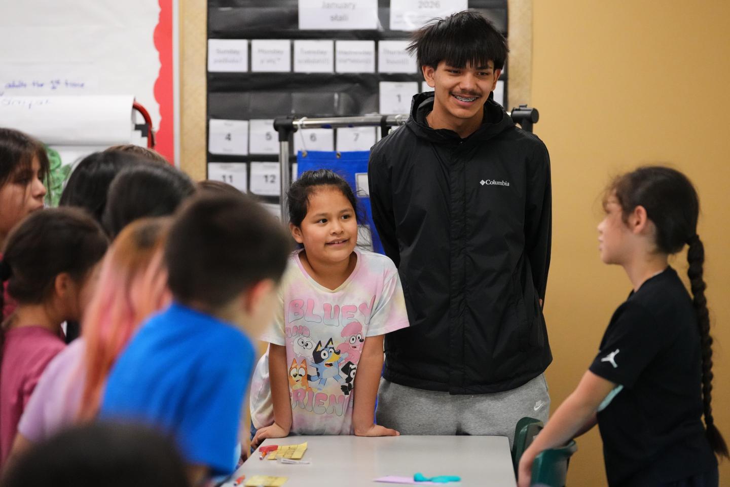 Kids near table in a school setting