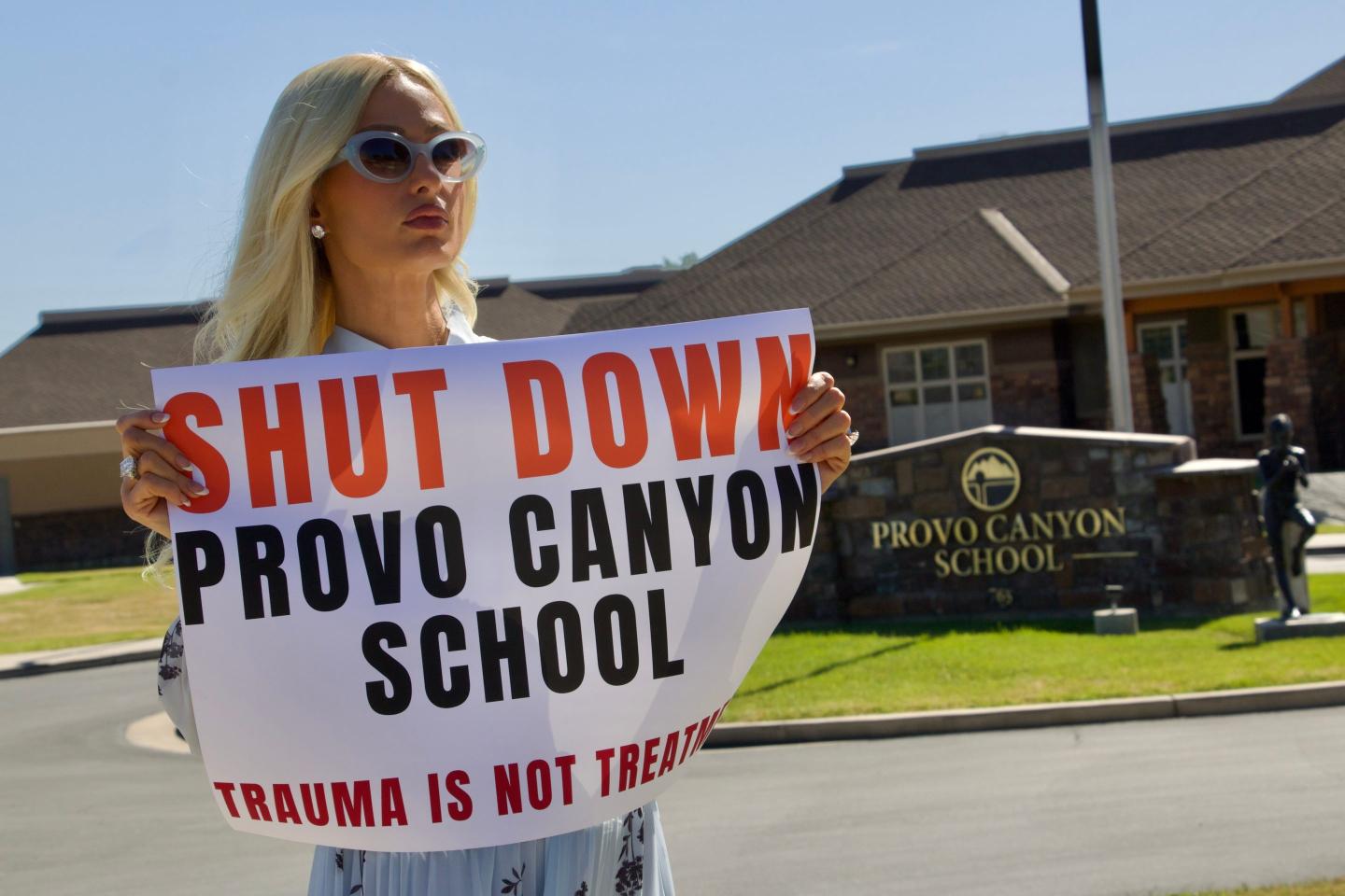 Paris Hilton protests outside the Provo Canyon School, where she says she suffered abuse as a teen, Monday, June 15, 2026, in Springville, Utah.