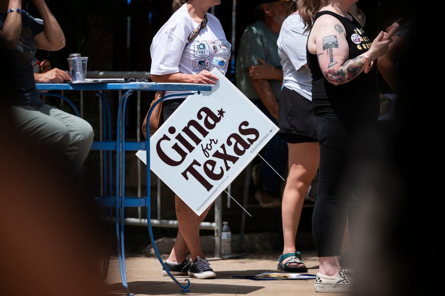 A supporter holds a sign for Democratic candidate for Texas governor Gina Hinojosa while she speaks during a rally.