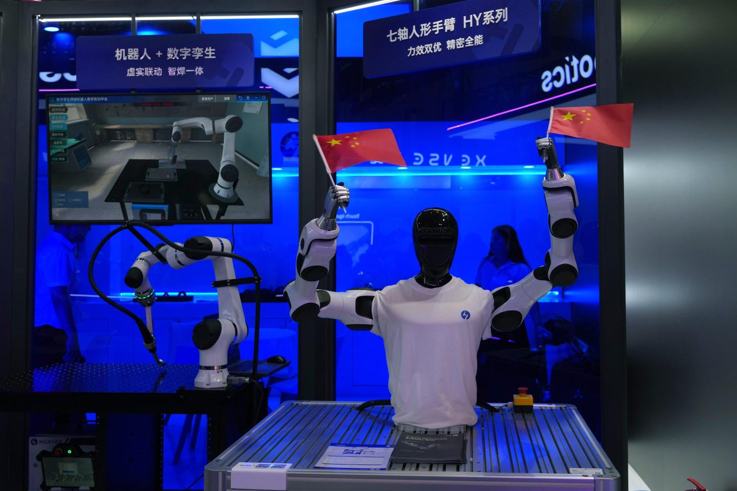 Photo of humanoid robot waving Chinese national flags
