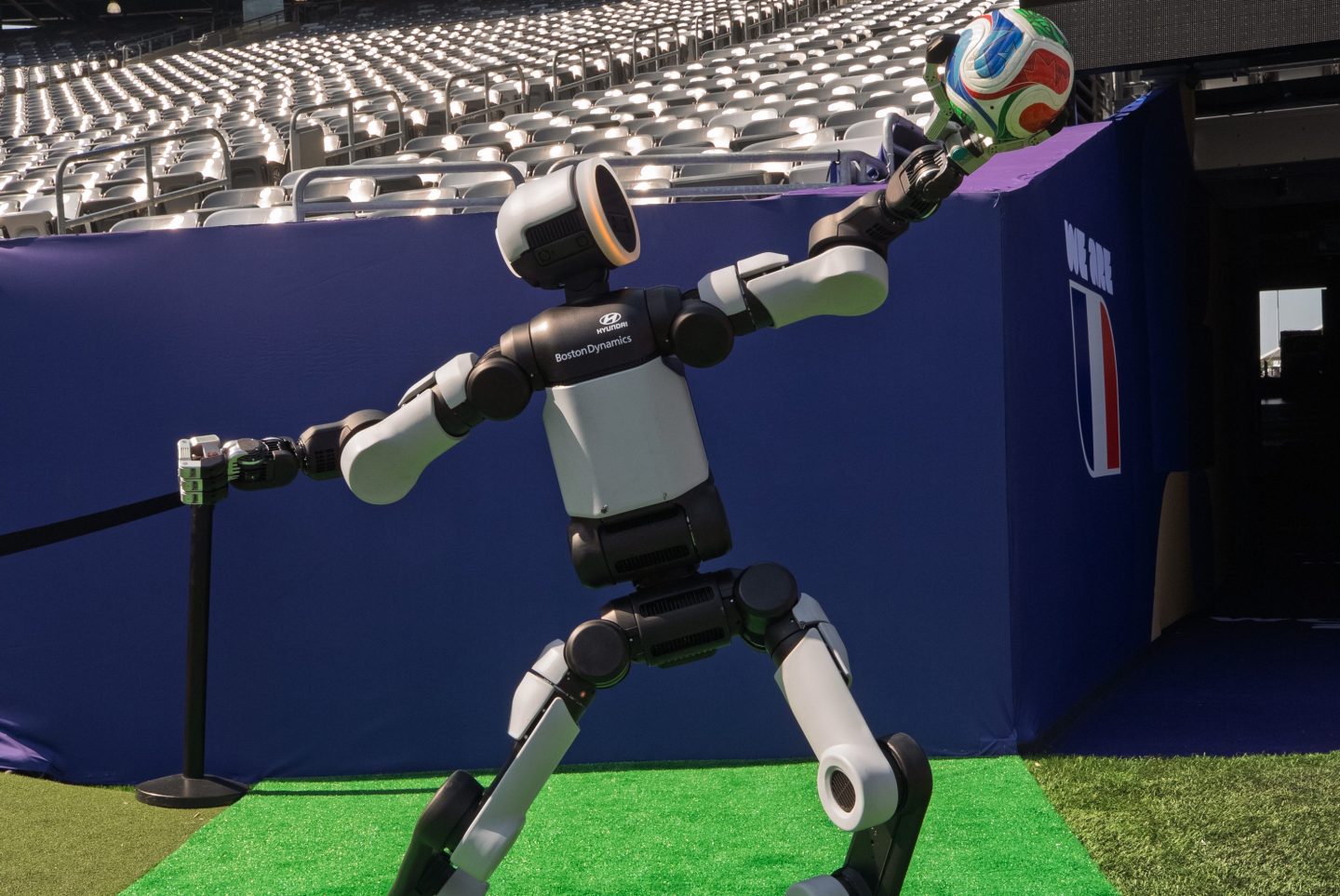 Humanoid robot holding soccer ball.