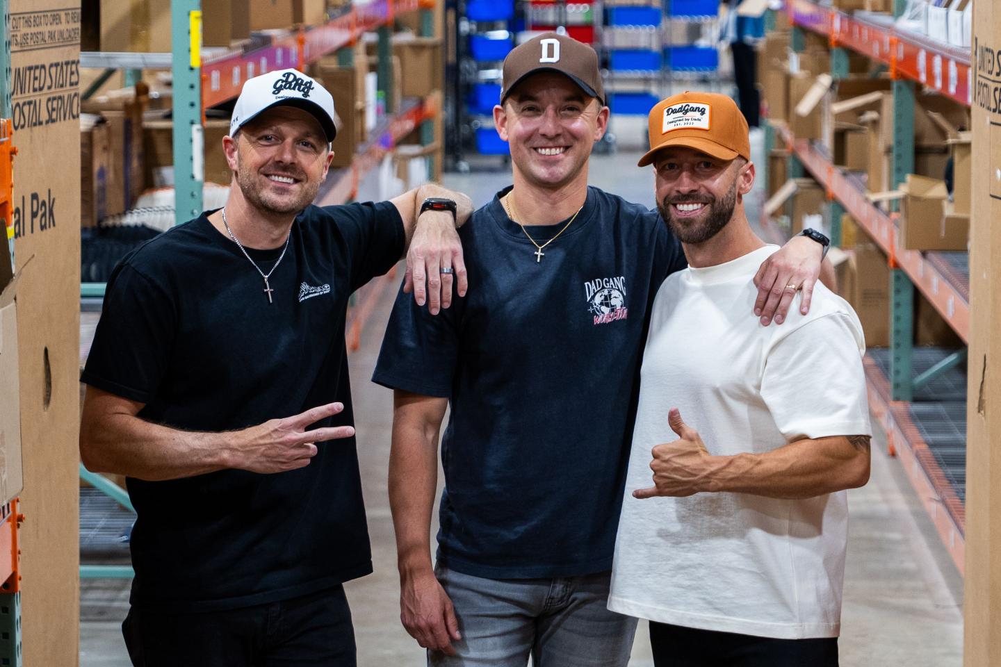 Ejay O'Donnell, Bart Szaniewski, and Grant Eastey wear Dad Gang hats in a factory