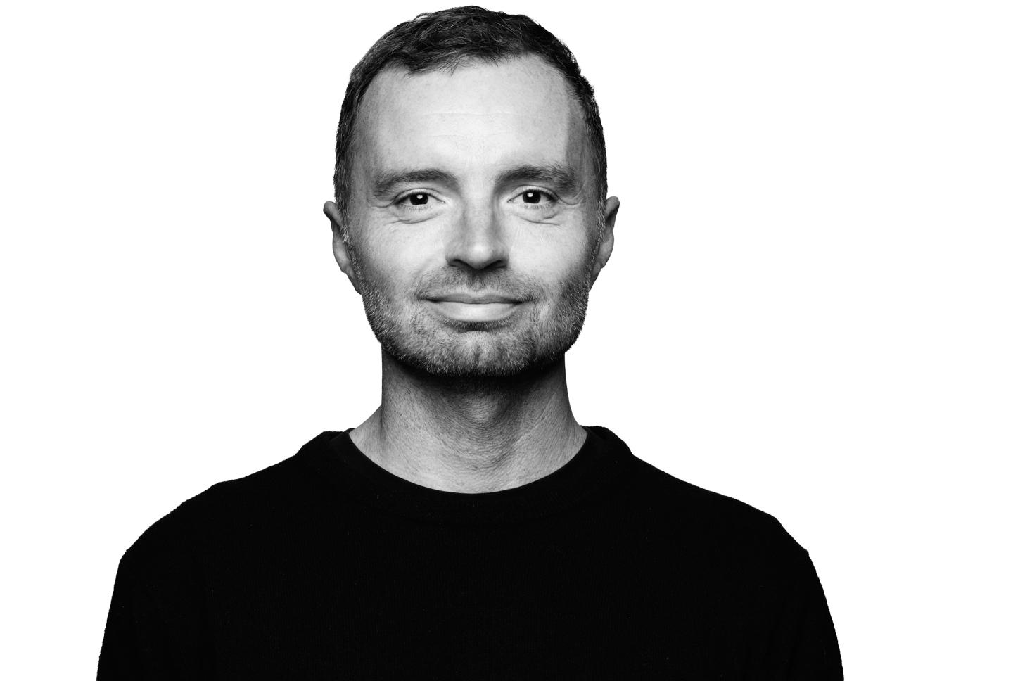 David Senra smiles in front of a white background