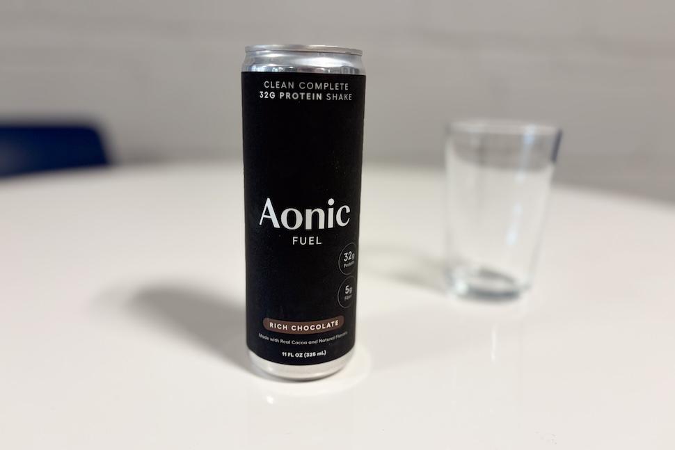 A black can of Aonic Fuel protein shake sits on a white countertop.