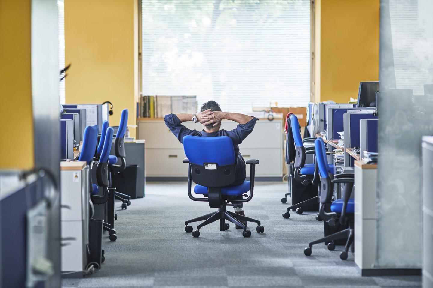 a man having chair still by the window in the office