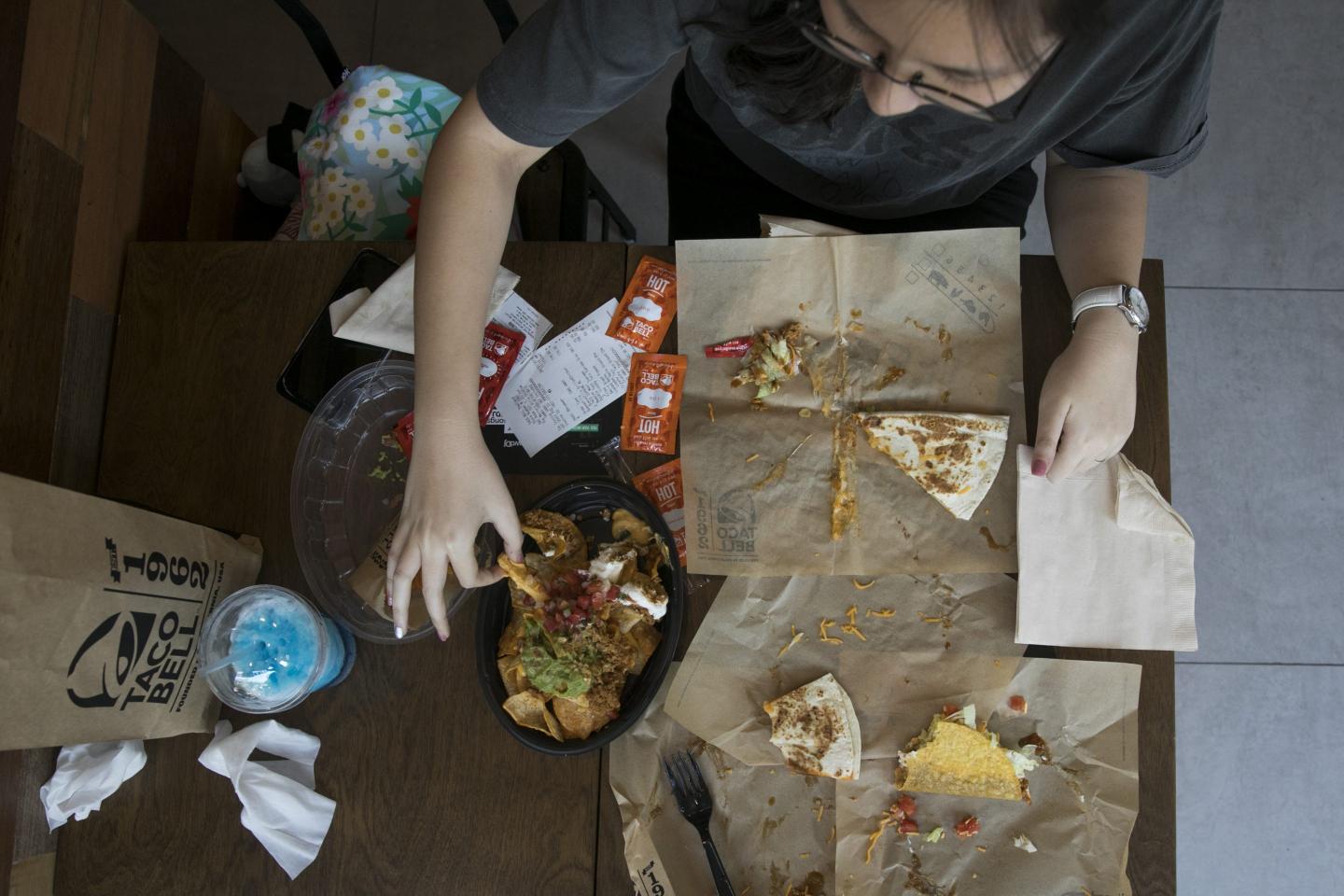 An aerial view of a person eating Taco Bell