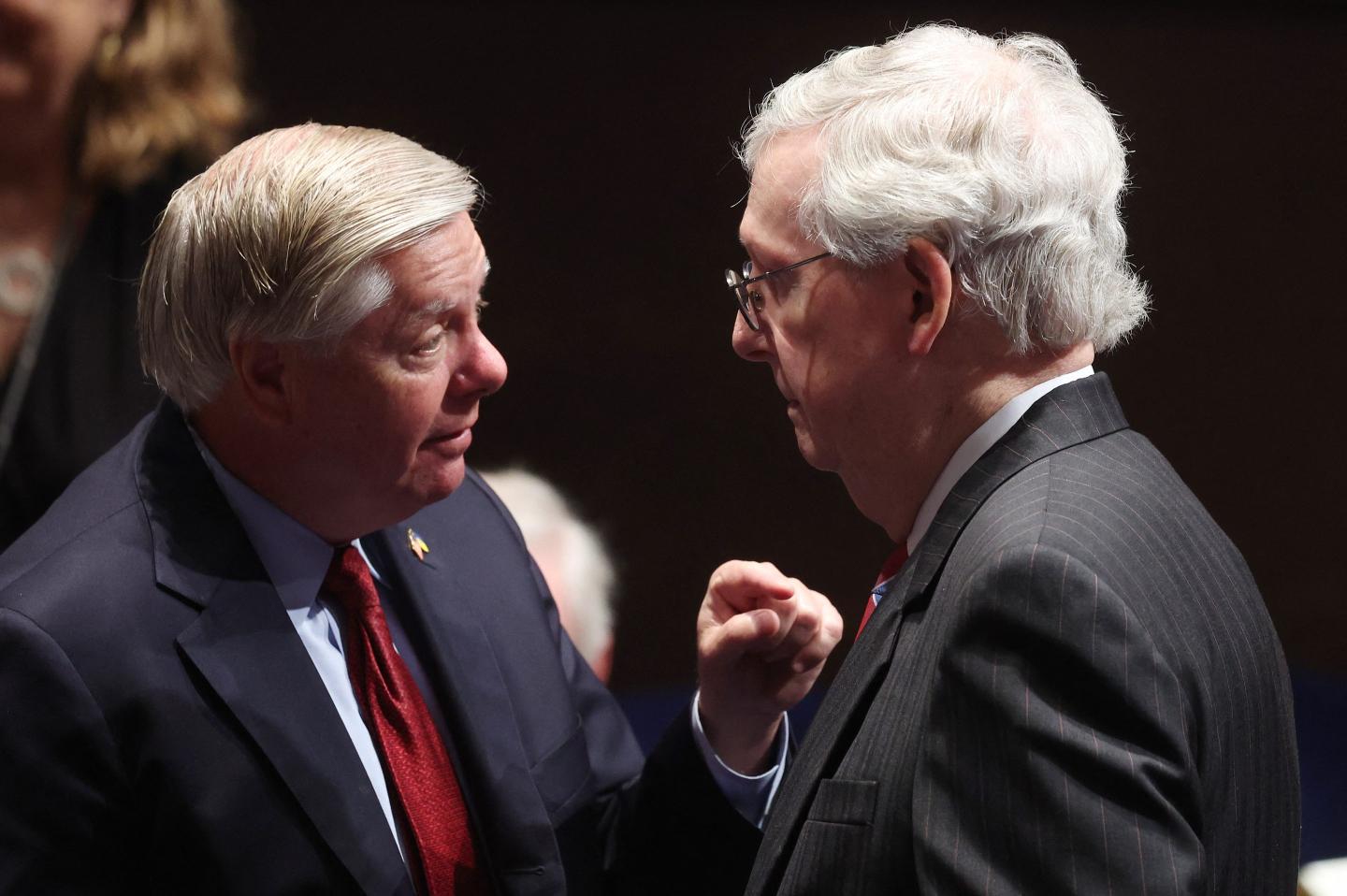 Lindsey Graham and Mitch McConnell face each other.