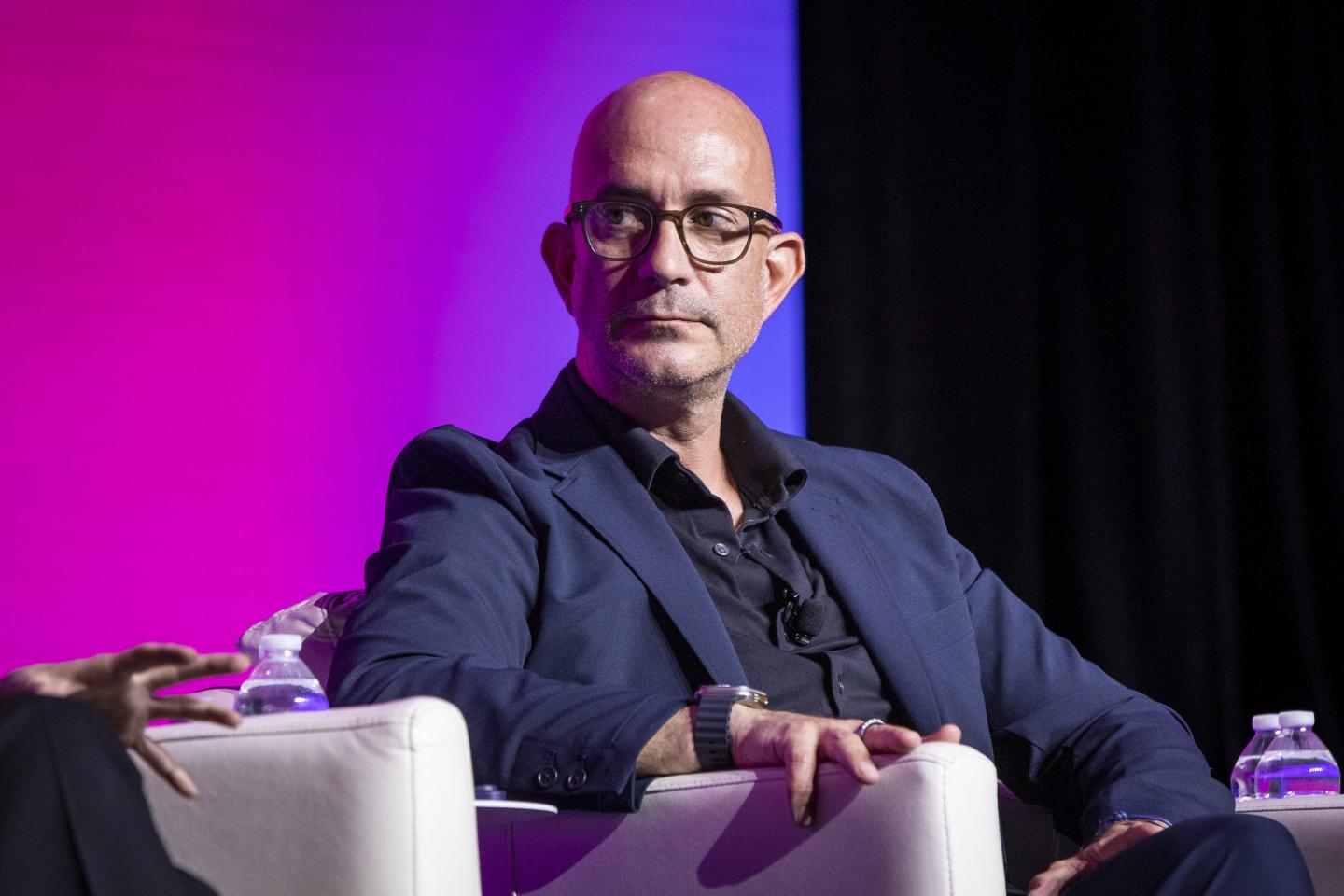 Securitize CEO Carlos Domingo looks to the far right during a conference.