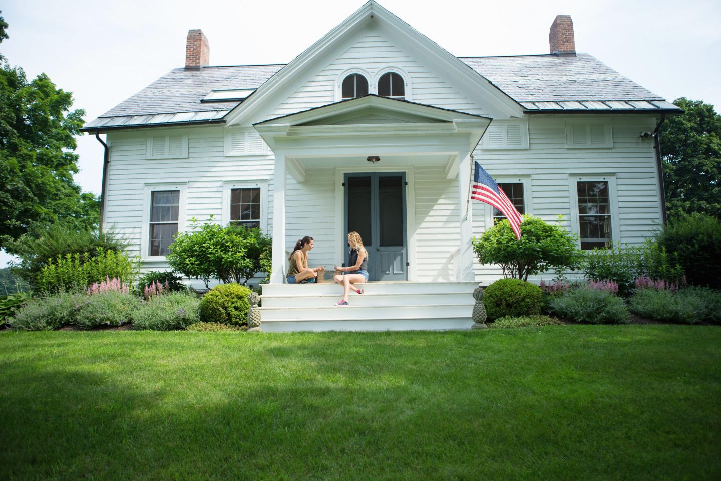 Sisters sitting on a porch
