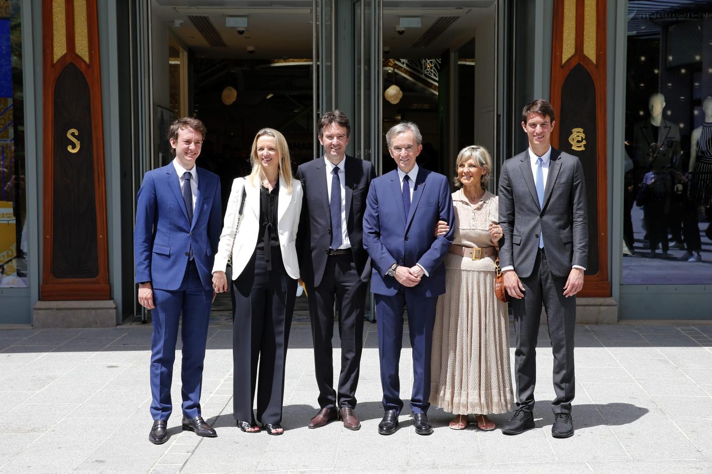 Head of French multinational corporation LVMH Bernard Arnault (C) and his wife Helene (2R), pose with their children (from L-R) Frederic Arnault, Delphine Arnault, Antoine Arnault and Alexandre Arnault after the ceremony marking Paris' Iconic department store 'La Samaritaine' reopening after 16 years of closure on June 21, 2021 in Paris, France.