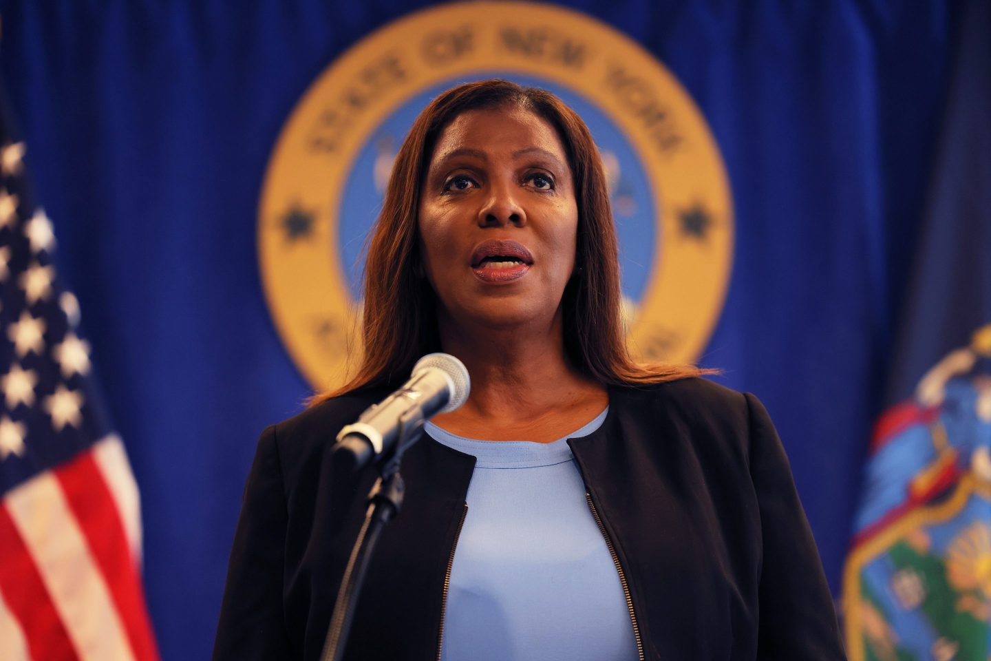 NY AG Letitia James speaks into a microphone.
