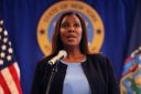 NY AG Letitia James speaks into a microphone.
