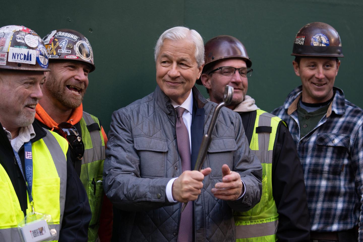 Jamie Dimon surrounded by construction workers.