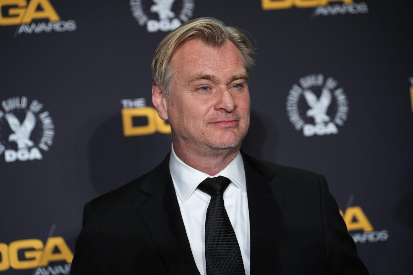 Christopher Nolan wearing a black suit