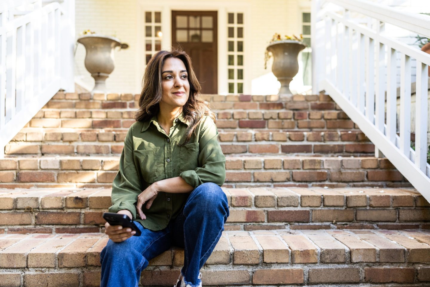 Woman sitting in front of her house