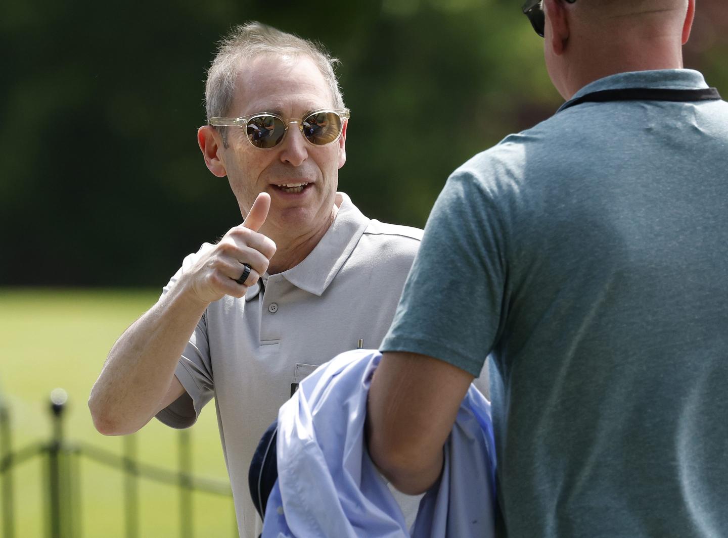 Man in a polo shirt gives a thumbs up