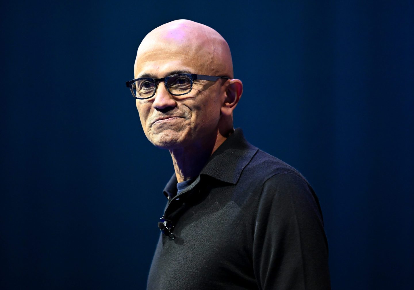 Man with glasses and a black collared shirt